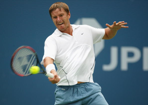 Kafelnikov returns a shot to Agassi