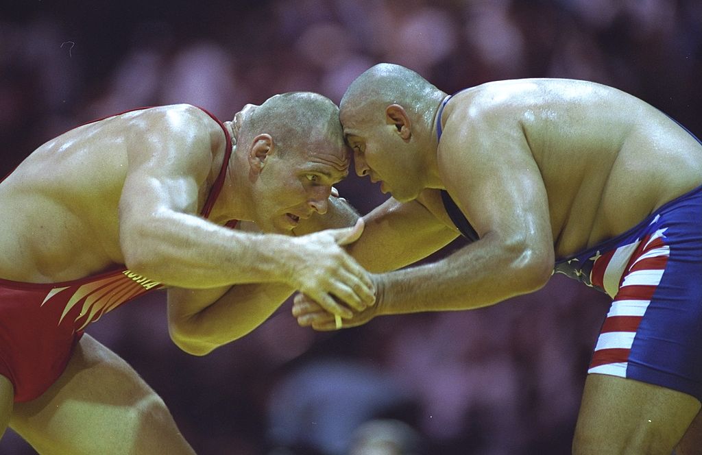 Alexander Karelin of Russia and Siamak Ghaffari of the USA square up to each other